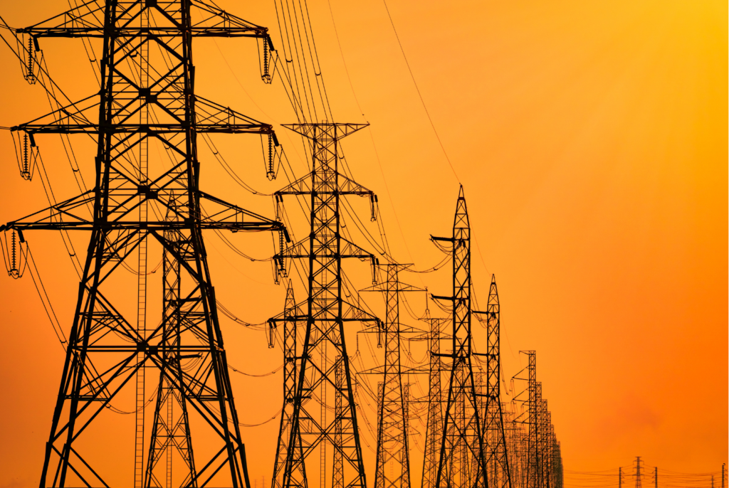 Overhead grid conductors navigating sub-transmission routes near urban load centers.